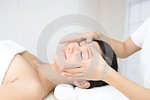 Beautiful young woman receiving facial massage