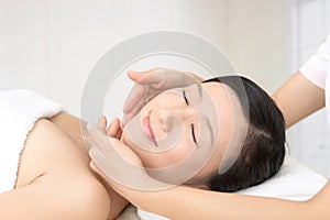 Beautiful young woman receiving facial massage