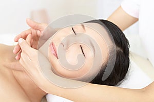 Beautiful young woman receiving facial massage