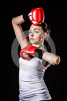 Beautiful young woman in a red boxing gloves