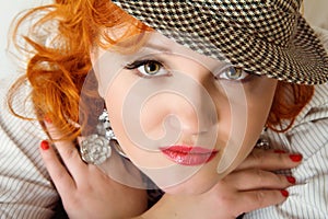 Young woman with red hairs in fedora hat