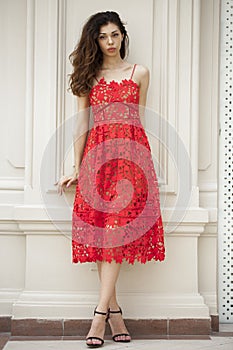 Beautiful young woman in red dress