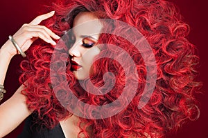 Beautiful young woman with red hair. Bright make-up and hairstyle