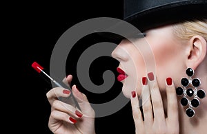 Beautiful young woman with red lips and manicure