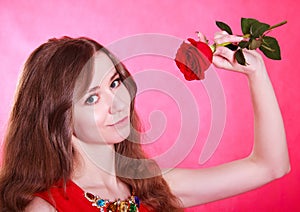 Beautiful young woman with a red rose