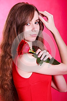 Beautiful young woman with a red rose