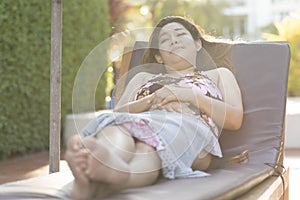 Beautiful young woman relaxing on beach chair