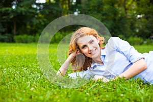 Beautiful young woman relaxing in grass