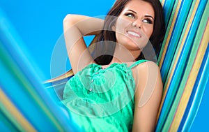 Beautiful young woman relaxing in hammock