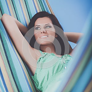 Beautiful young woman relaxing in hammock