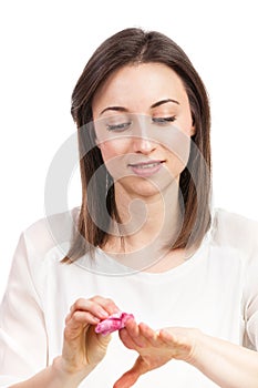 Beautiful young woman removing fingernail polish