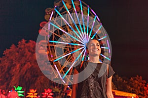 Beautiful young woman resting in an amusement Park. Concept of summer festivals, recreation and entertainment