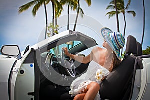 Beautiful young woman resting in her car