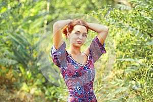 Beautiful young woman resting in summer Park , enjoying nature outdoors.