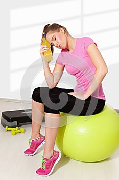 Beautiful young woman resting after tiring workout photo
