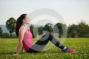 Beautiful young woman rests after a long run workout outdoor in