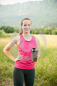 Beautiful young woman rests after a long run workout outdoor in nature