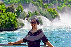 Beautiful young woman in Rhine falls in Switzerland