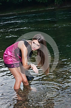 Beautiful young woman in the river