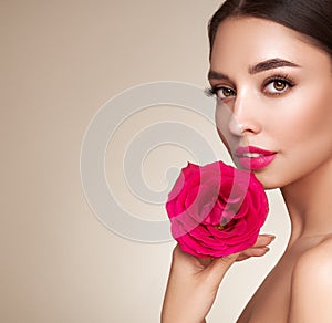 Beautiful young woman a rose flower