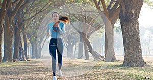 beautiful young woman running in the park at morning