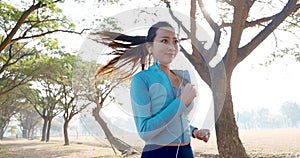 beautiful young woman running in the park at morning