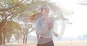 beautiful young woman running in the park at morning