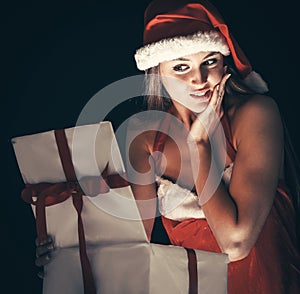 beautiful young woman in Santa Claus costume with Christmas shopping.