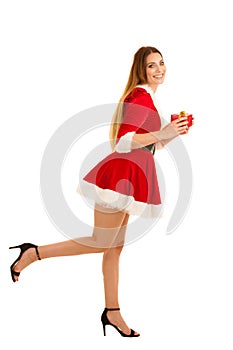 Beautiful young woman in santa claus dress hods a present isolated over white background