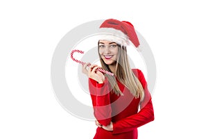 Beautiful young woman with santa hat holding a festive candy can