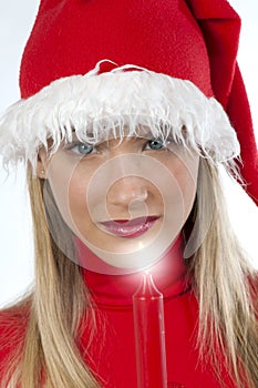 Beautiful young woman in santa's hat holding a