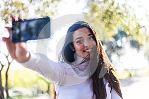 Beautiful young woman selfie in the park