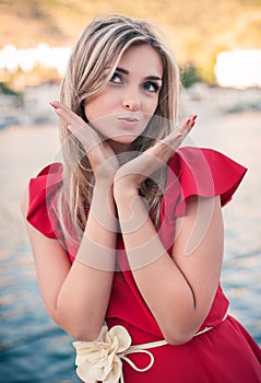 Beautiful, young woman sends an air kiss