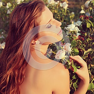 Beautiful young woman sensual look in the garden in summer. vintage photo