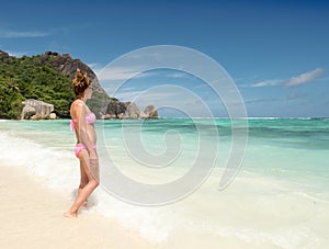 Beautiful young woman in Seychelles tropical beach.