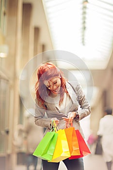 Beautiful young woman shopping in the city, mall with shopping bag