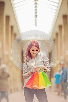 Beautiful young woman shopping in the city, mall with shopping bag