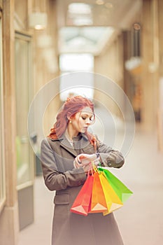 Beautiful young woman shopping in the city, mall with shopping bag