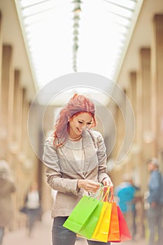 Beautiful young woman shopping in the city, mall with shopping bag