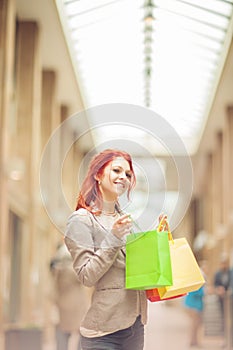 Beautiful young woman shopping in the city, mall with shopping bag