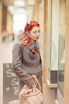 Beautiful young woman shopping in the city, mall with shopping bag