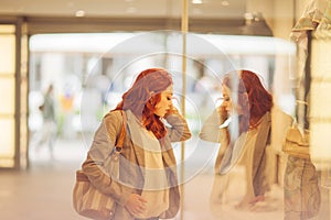 Beautiful young woman shopping in the city, mall with shopping bag