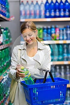 Beautiful young woman shopping in a grocery store