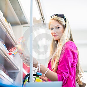 Beautiful young woman shopping in a grocery store/supermarket
