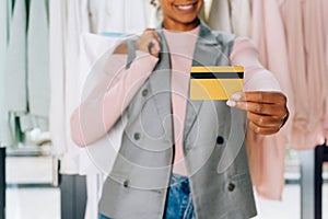 beautiful young woman showing credit card