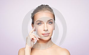 Beautiful young woman showing her cheekbone photo