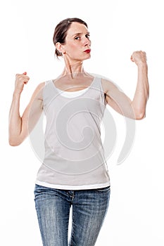 Beautiful young woman showing her muscles and strength with pride