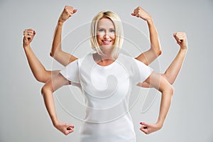 Beautiful young woman showing her muscularity and looking at camera