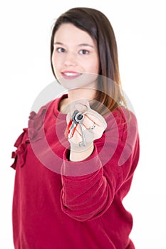 Beautiful young woman showing house keys