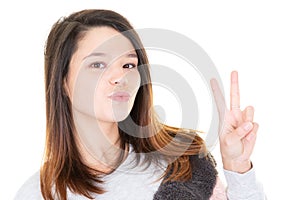 Beautiful young woman showing peace victory sign in white background